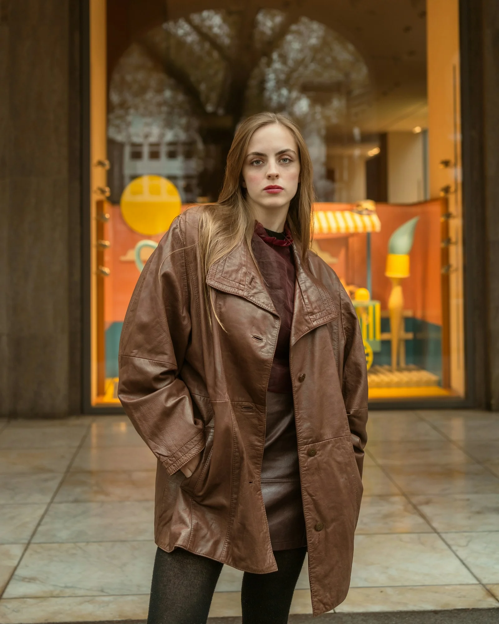 Woman posing in a vintage leather jacket