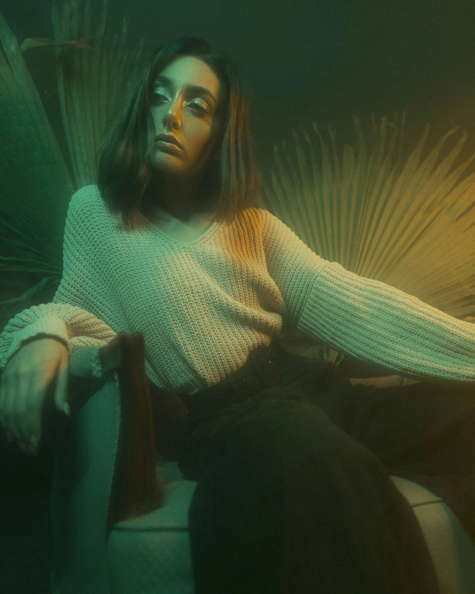woman in white knit sweater sitting on chair