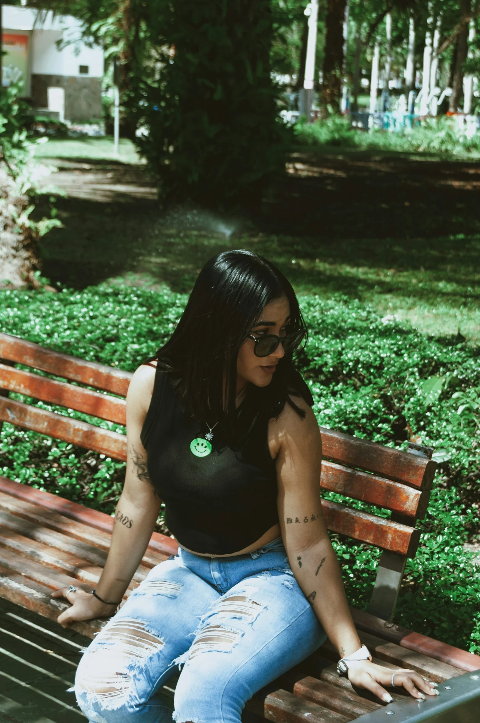 a woman sitting on top of a wooden bench