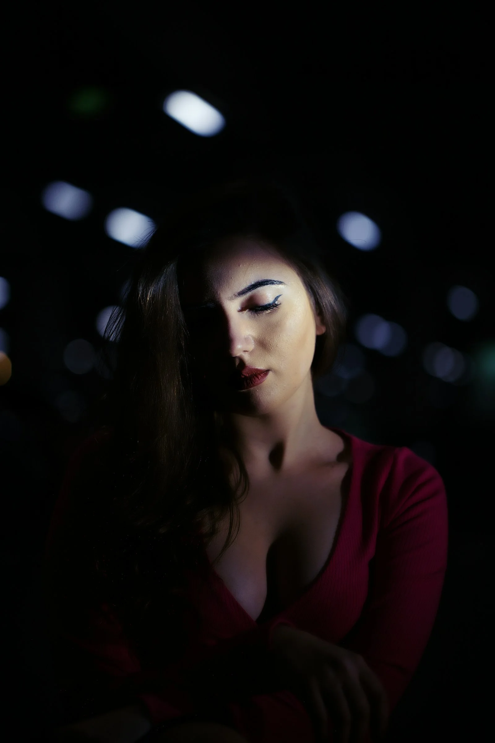 a woman in a red shirt is posing for a picture