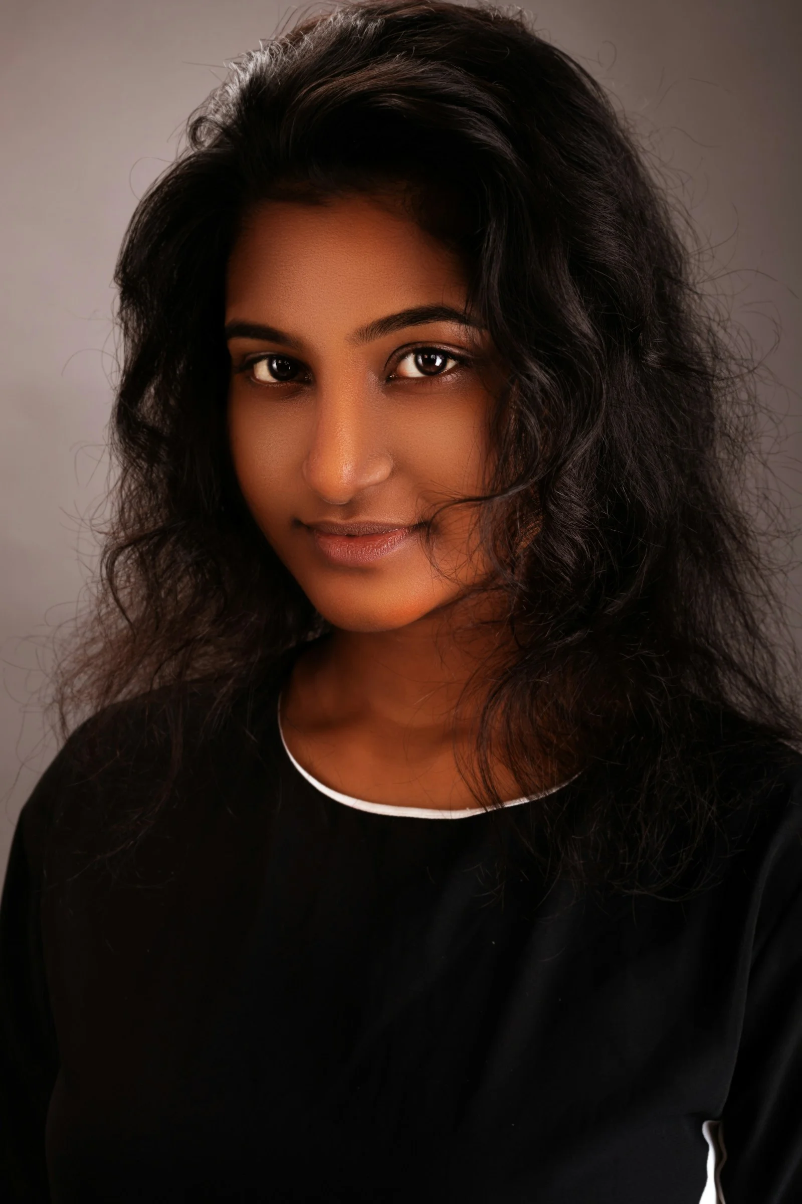 a woman with long hair and a black shirt