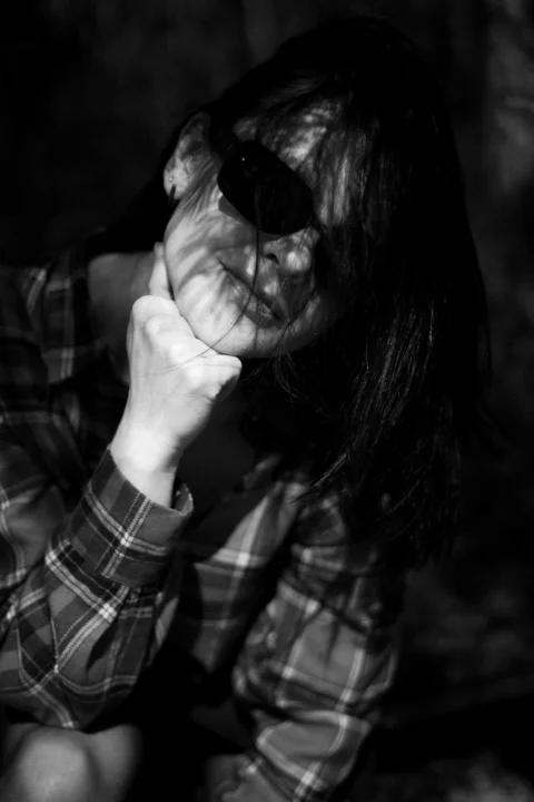 Woman in shadows is deep in thought
