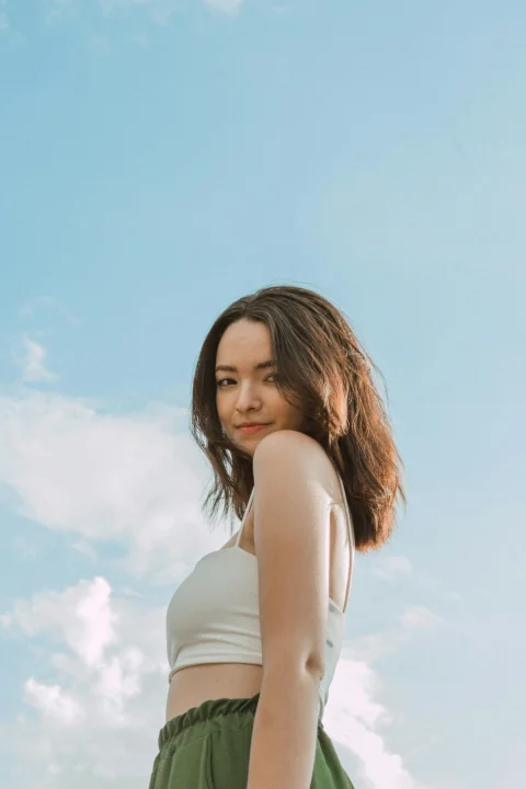 a woman standing in front of a blue sky