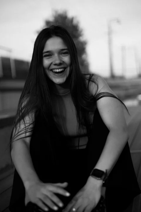 A happy woman laughing at the camera