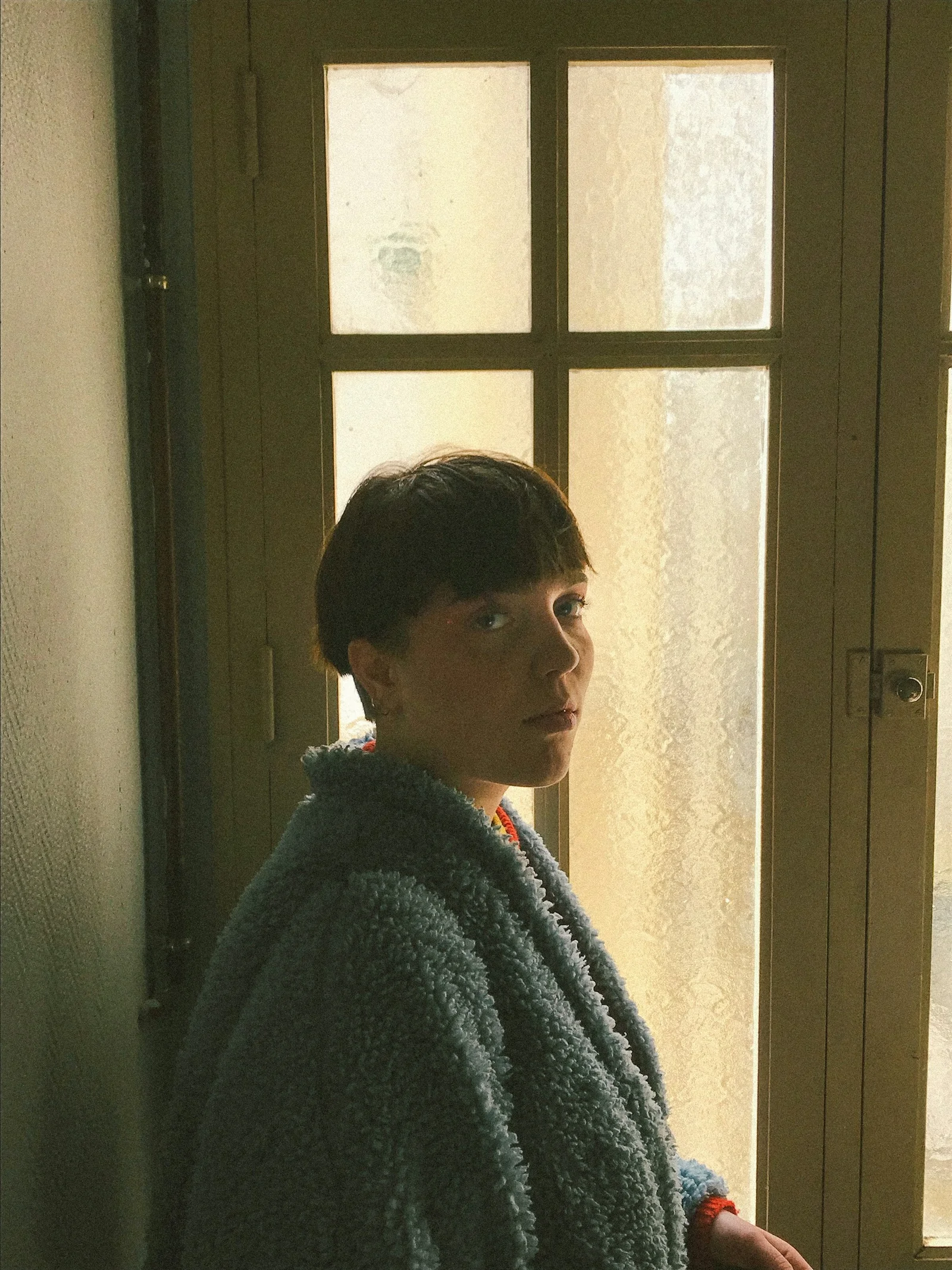 woman standing beside closed door
