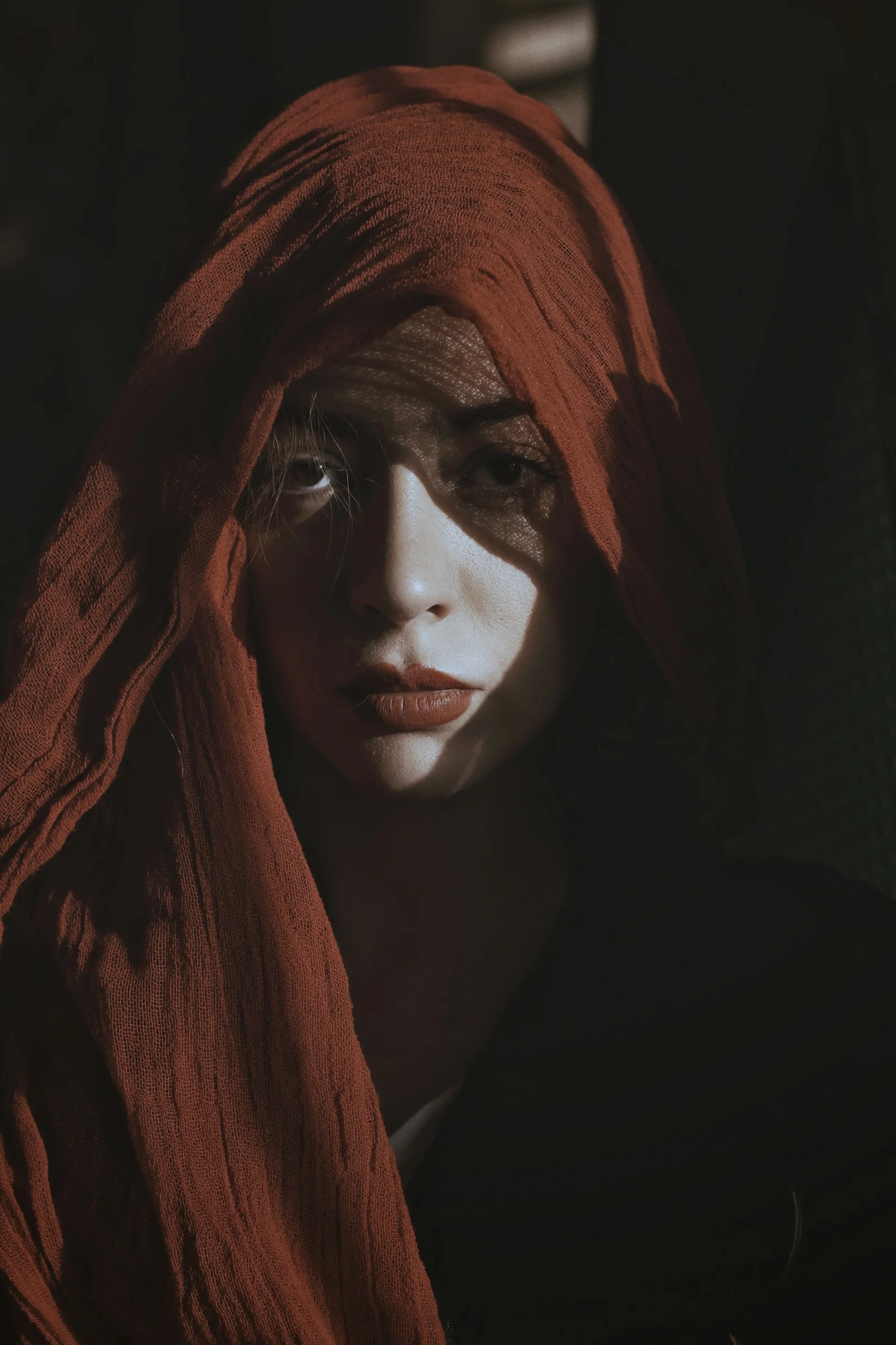 a woman with a red scarf on her head