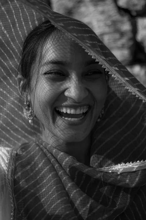a woman wearing a veil and smiling for the camera