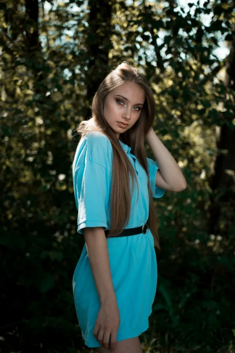 a woman in a blue dress posing for a picture