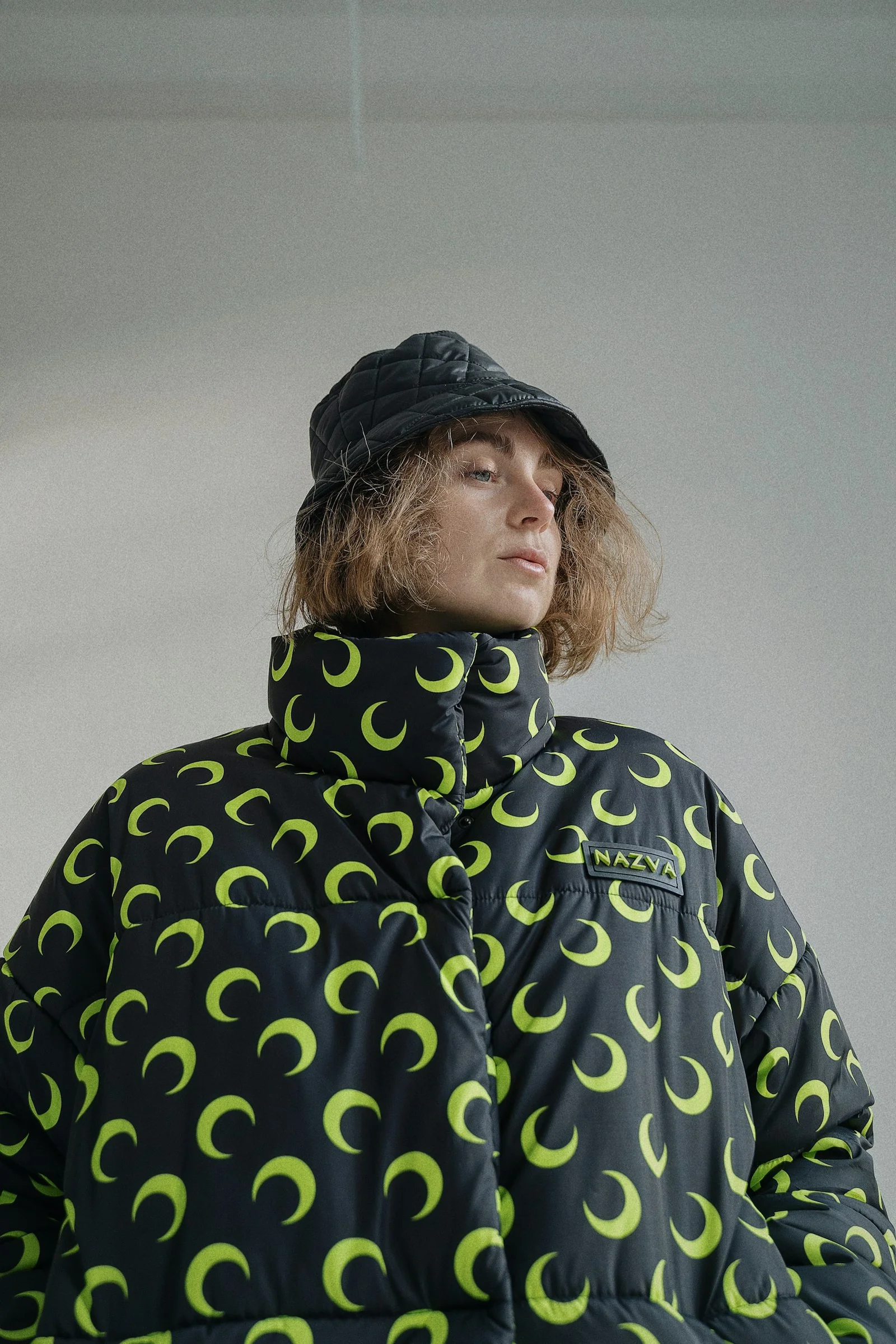 a woman wearing a black and green jacket