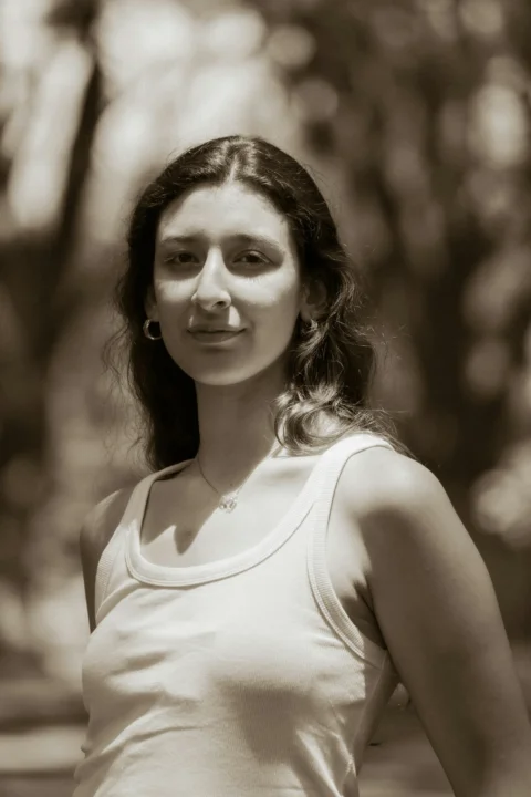 Young woman wearing a white tank top in sepia tone