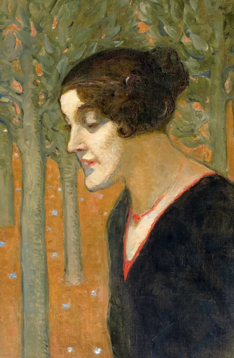 A woman's profile portrait with trees in background