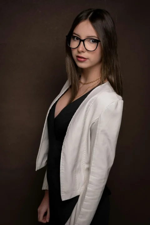 Young woman wearing glasses and a white jacket