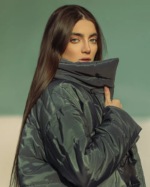 a woman with long hair wearing a black jacket