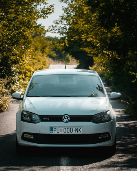 a white car parked on the side of a road