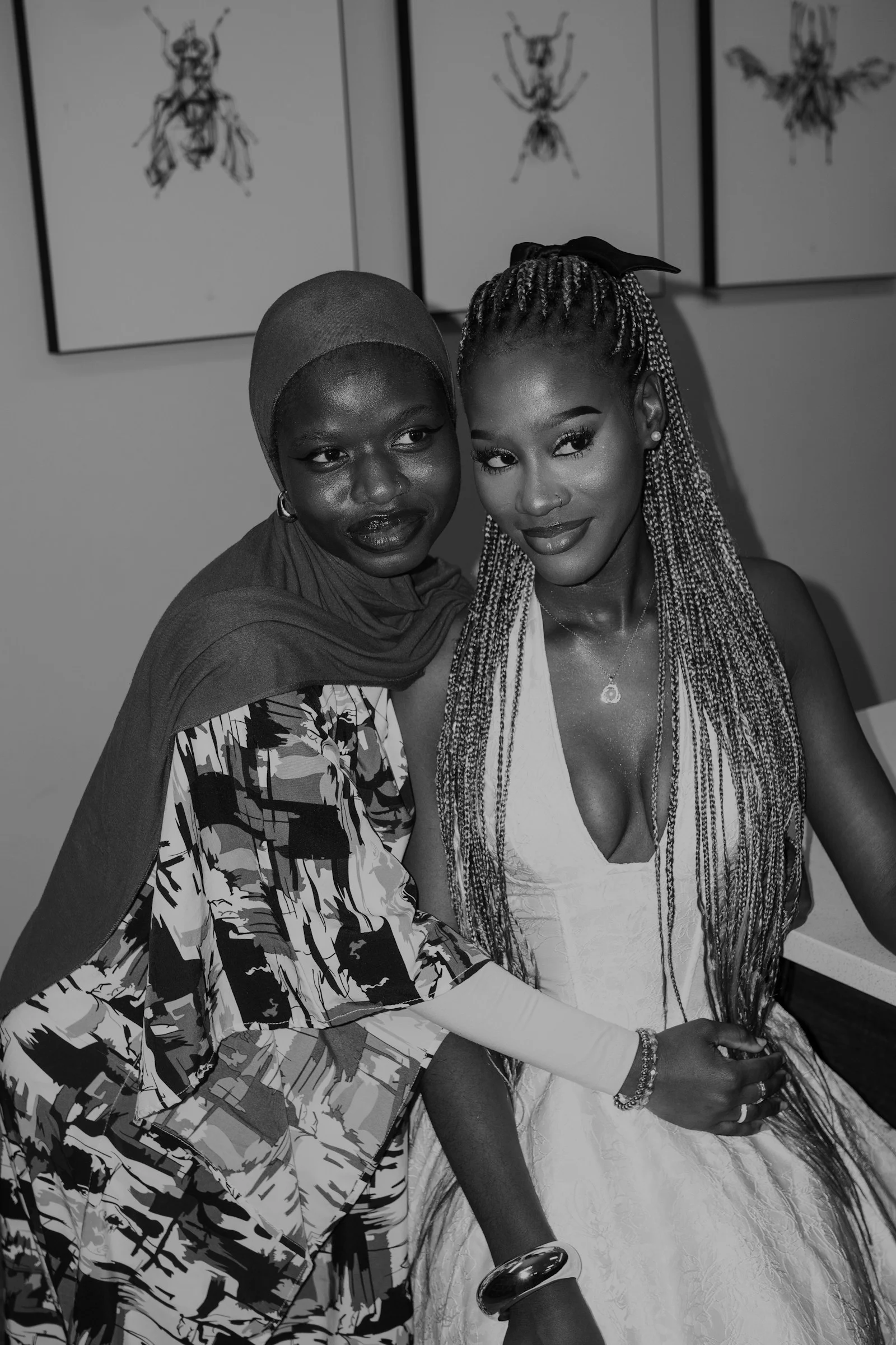Two women pose closely together, smiling for the camera