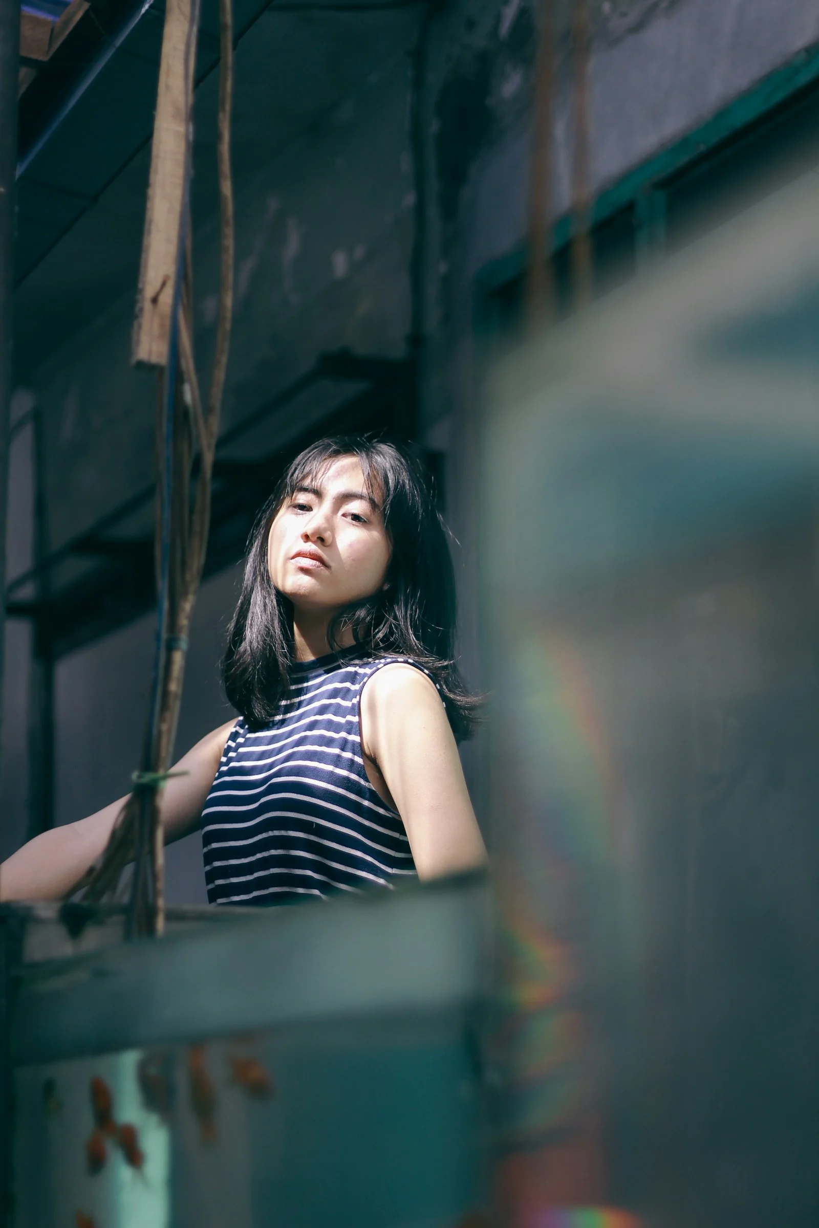 a woman standing next to a window in a building