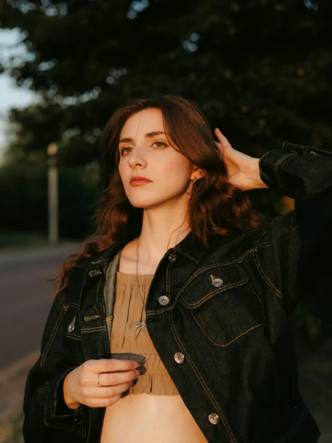 Young woman with long hair in golden hour sunlight