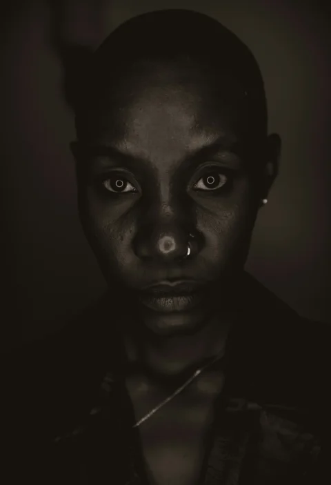 Close-up of a woman's face with dramatic lighting
