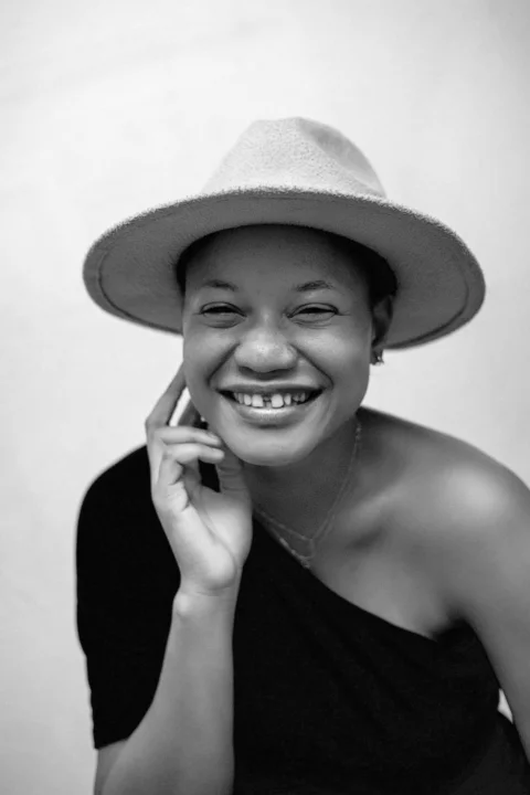 A woman in a hat talking on a cell phone