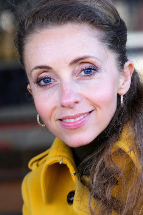 woman in yellow hoodie smiling