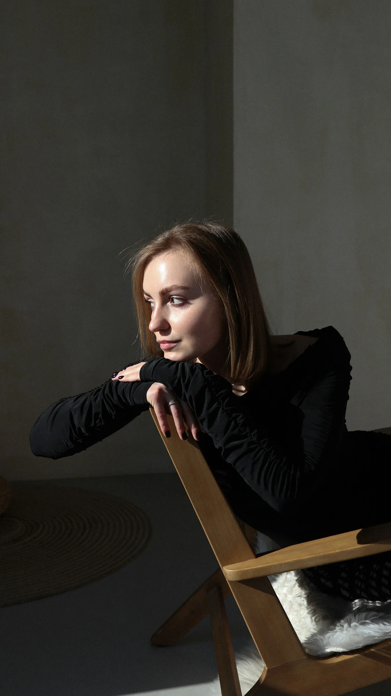 a woman sitting in a chair in a room