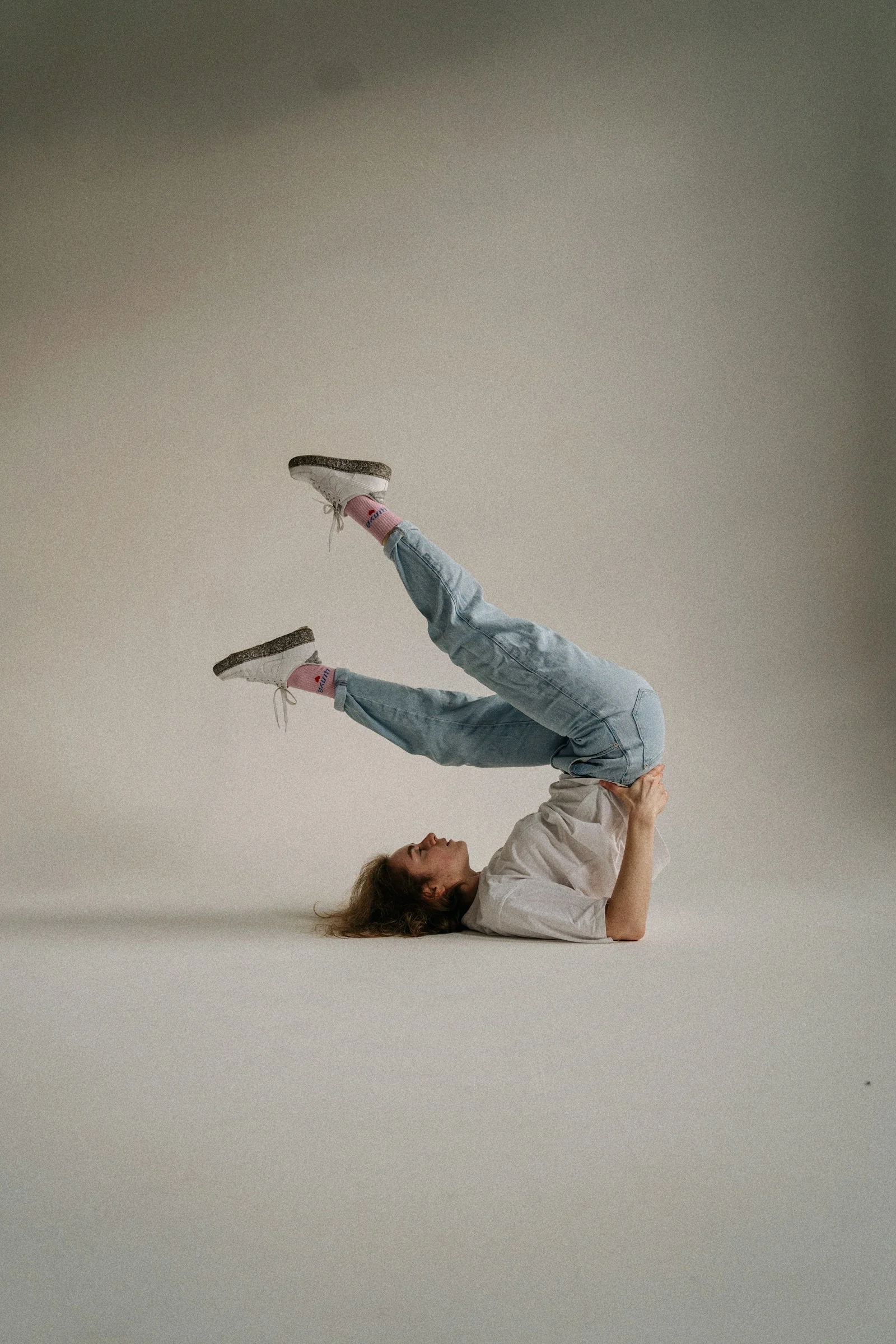 a woman is doing a handstand on her feet