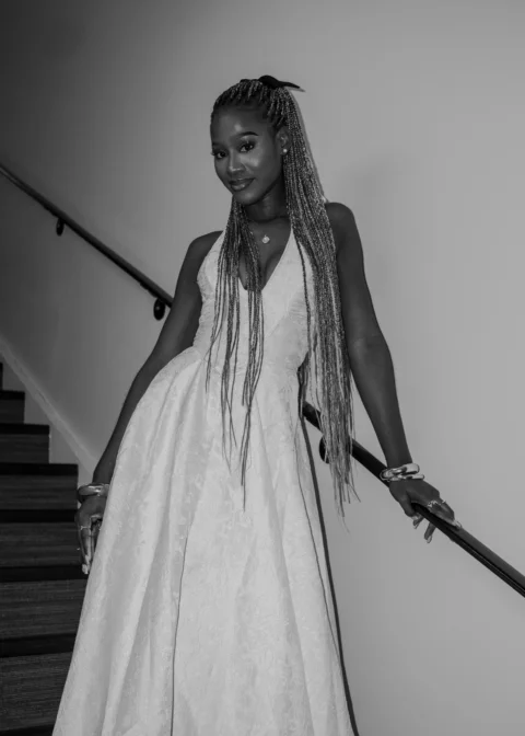 Woman in gown poses on a staircase