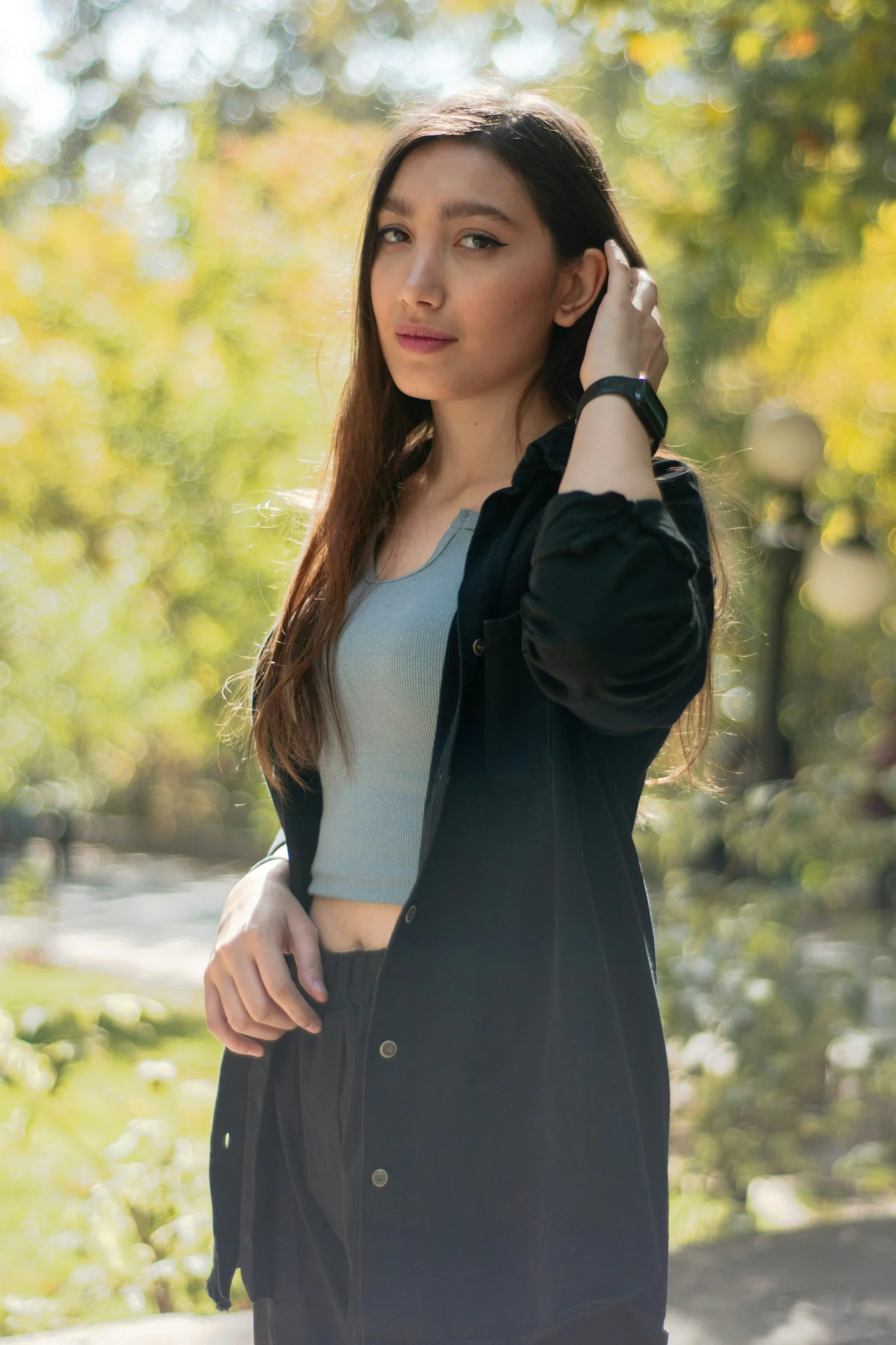 Young woman with long brown hair in park