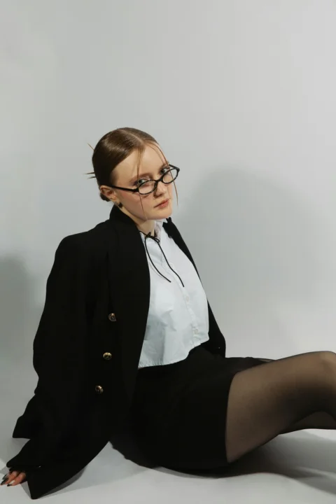 Woman in a suit poses, looking at the camera