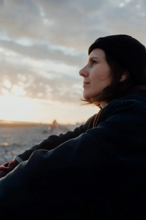A person looks out at the sunset