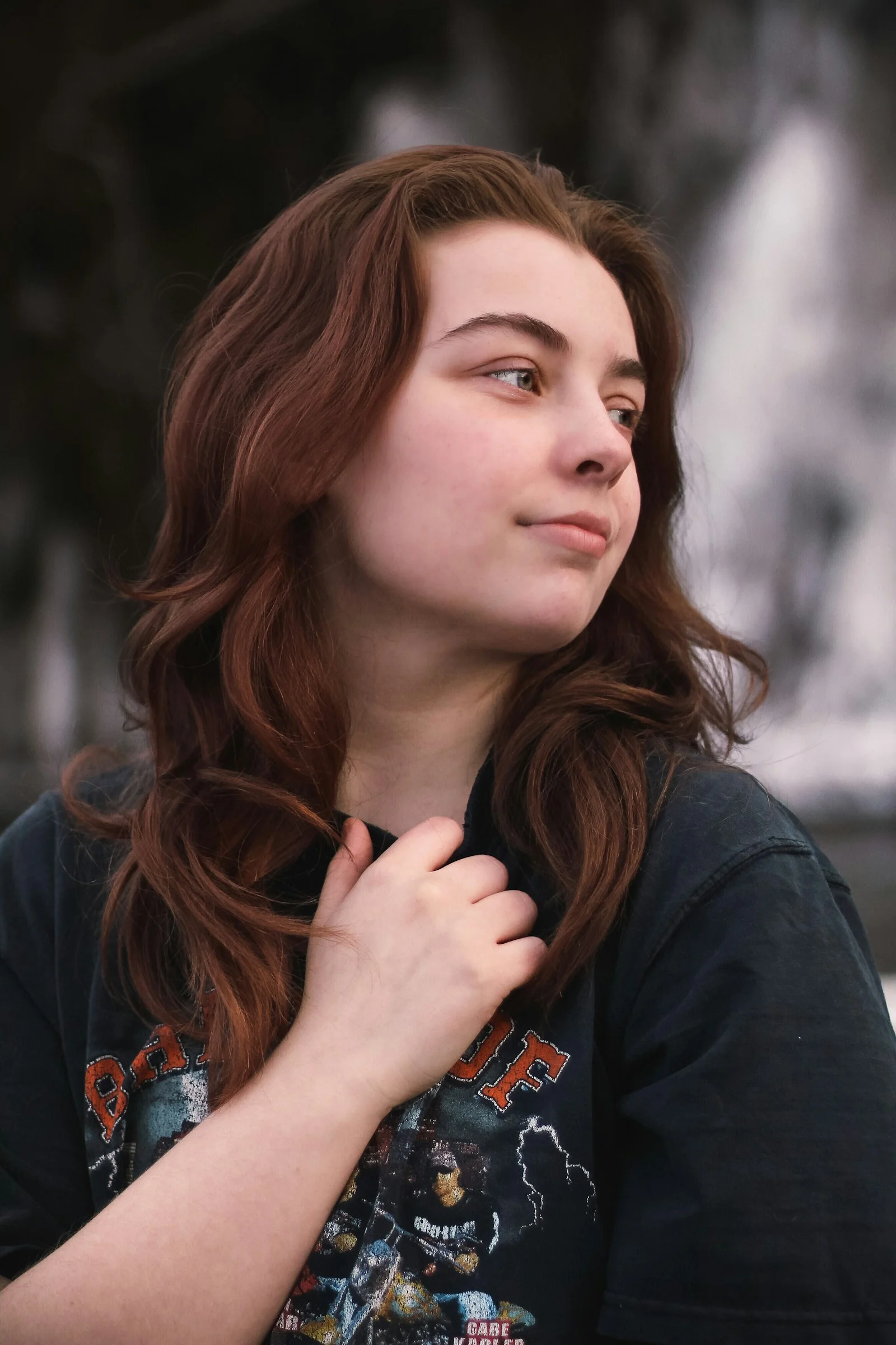 a woman with red hair and a black shirt
