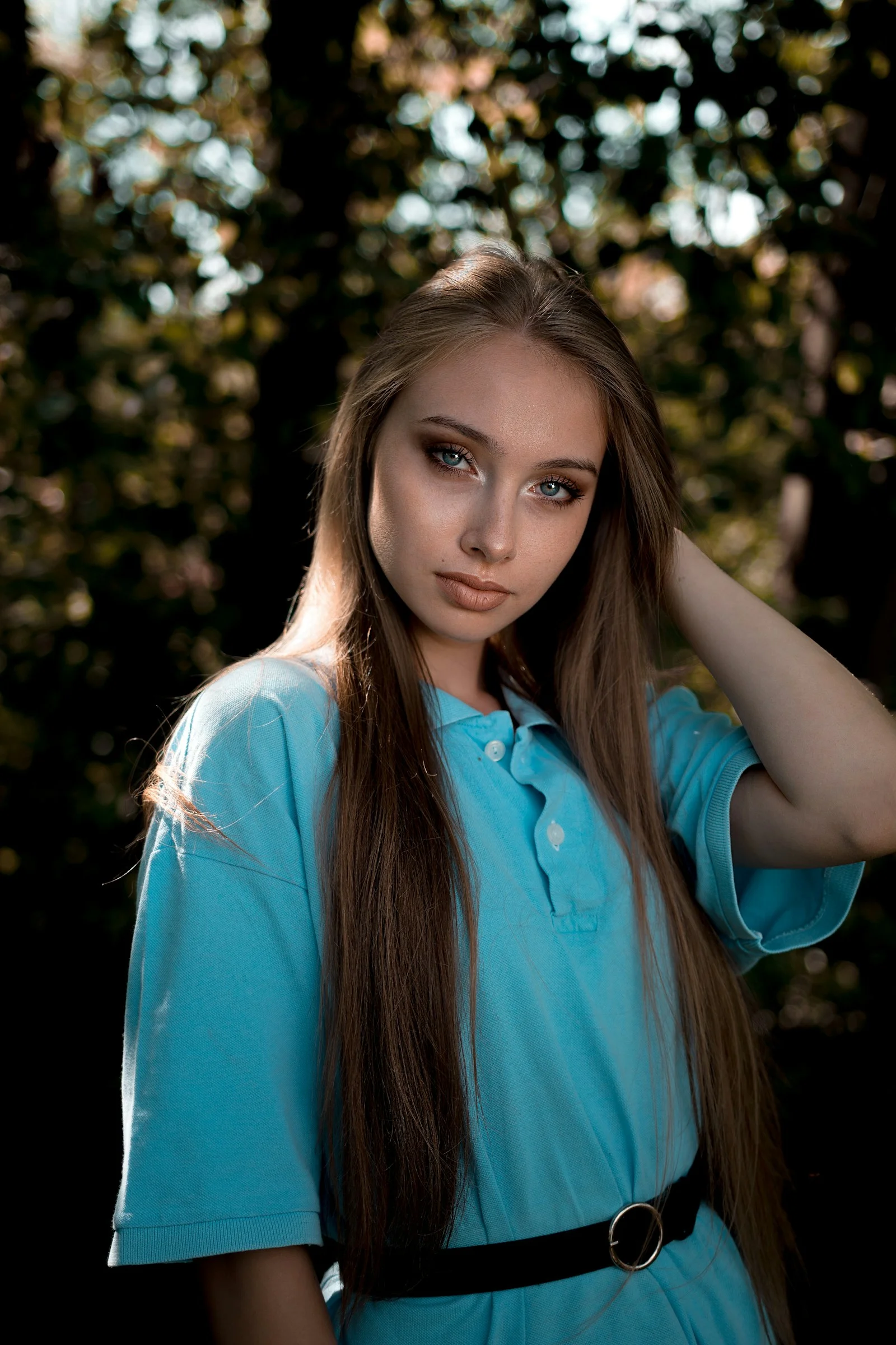 a woman with long hair wearing a blue shirt