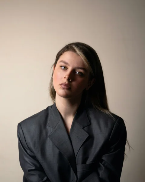A woman in a suit posing for a picture