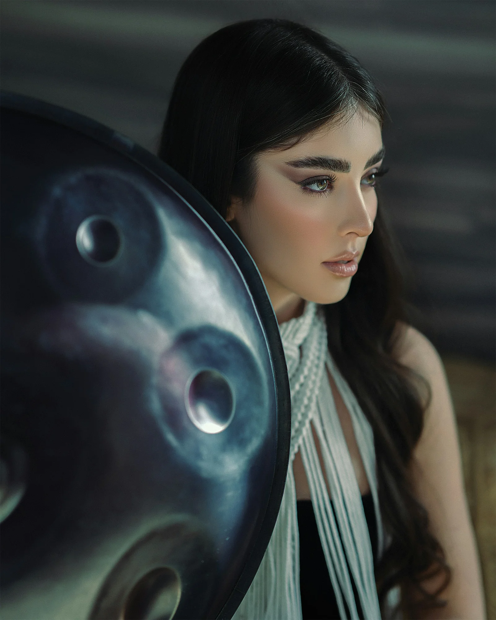 a woman holding a large metal object in her hands