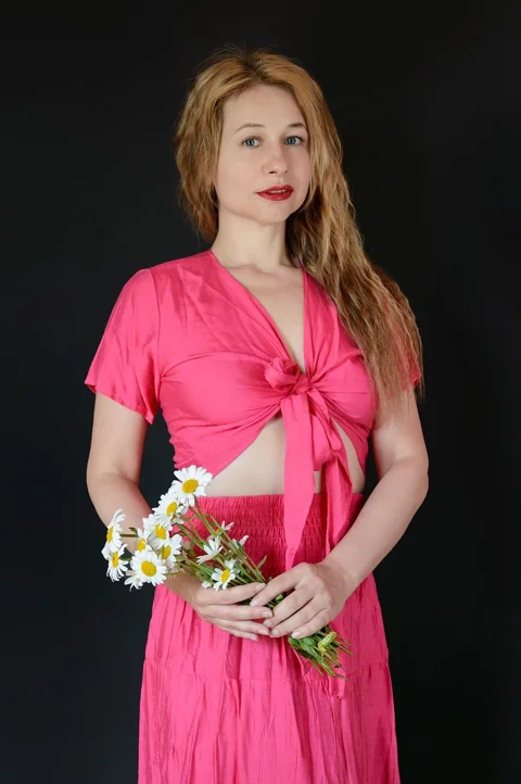 woman, pink-dress, black-background, red-lipstick