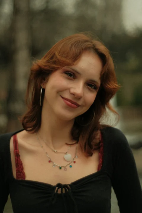 A woman in a black top smiling at the camera