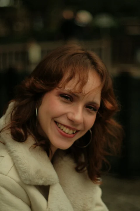 A woman in a white coat smiling at the camera
