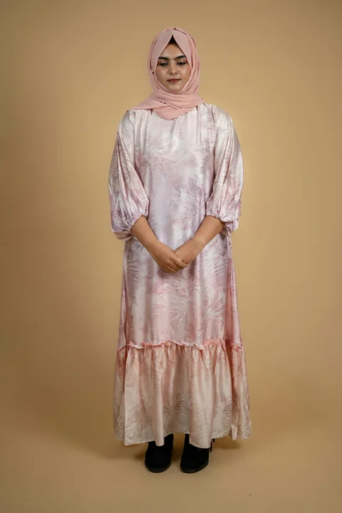 a woman wearing a pink dress and a headscarf