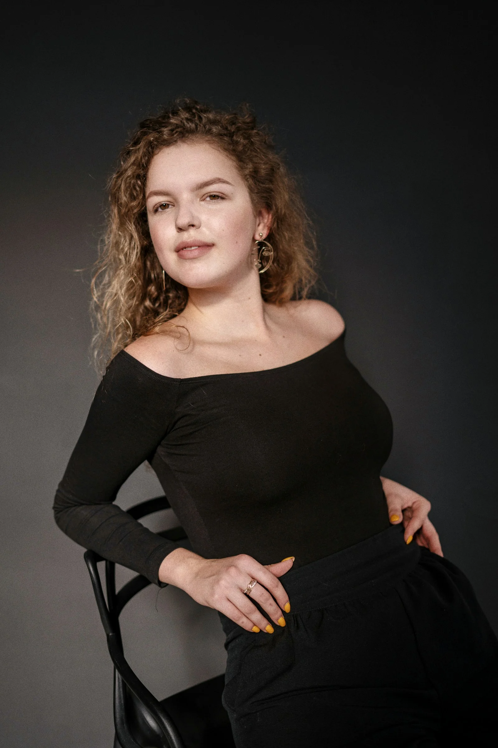a woman sitting in a chair posing for a picture