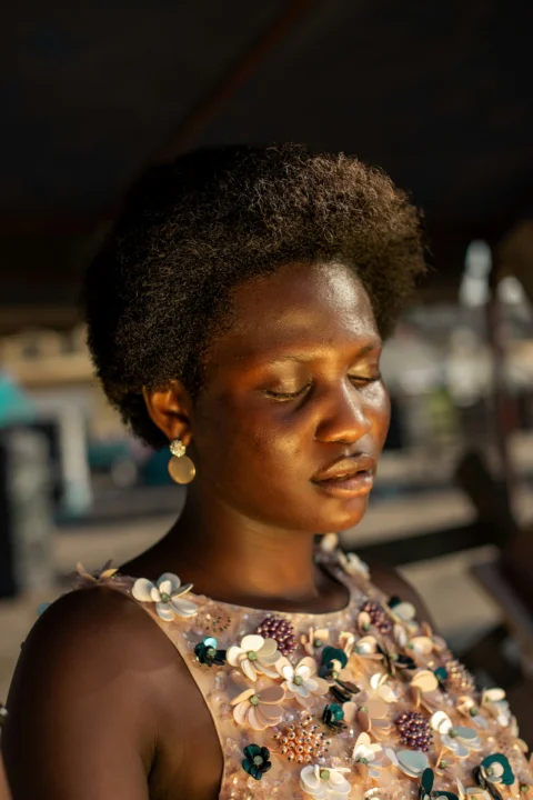 Woman with closed eyes and natural hair in warm light
