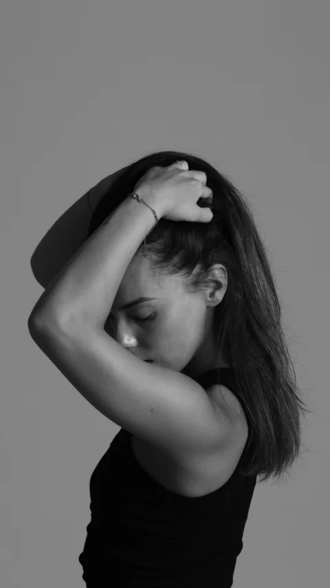 A woman is playing with her hair