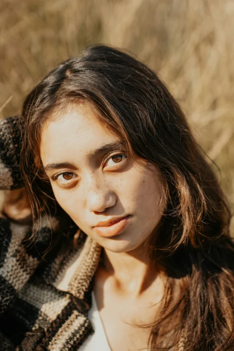 A young woman is posing for a picture