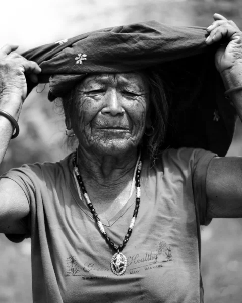 grayscale photo of man in crew neck t-shirt holding hat