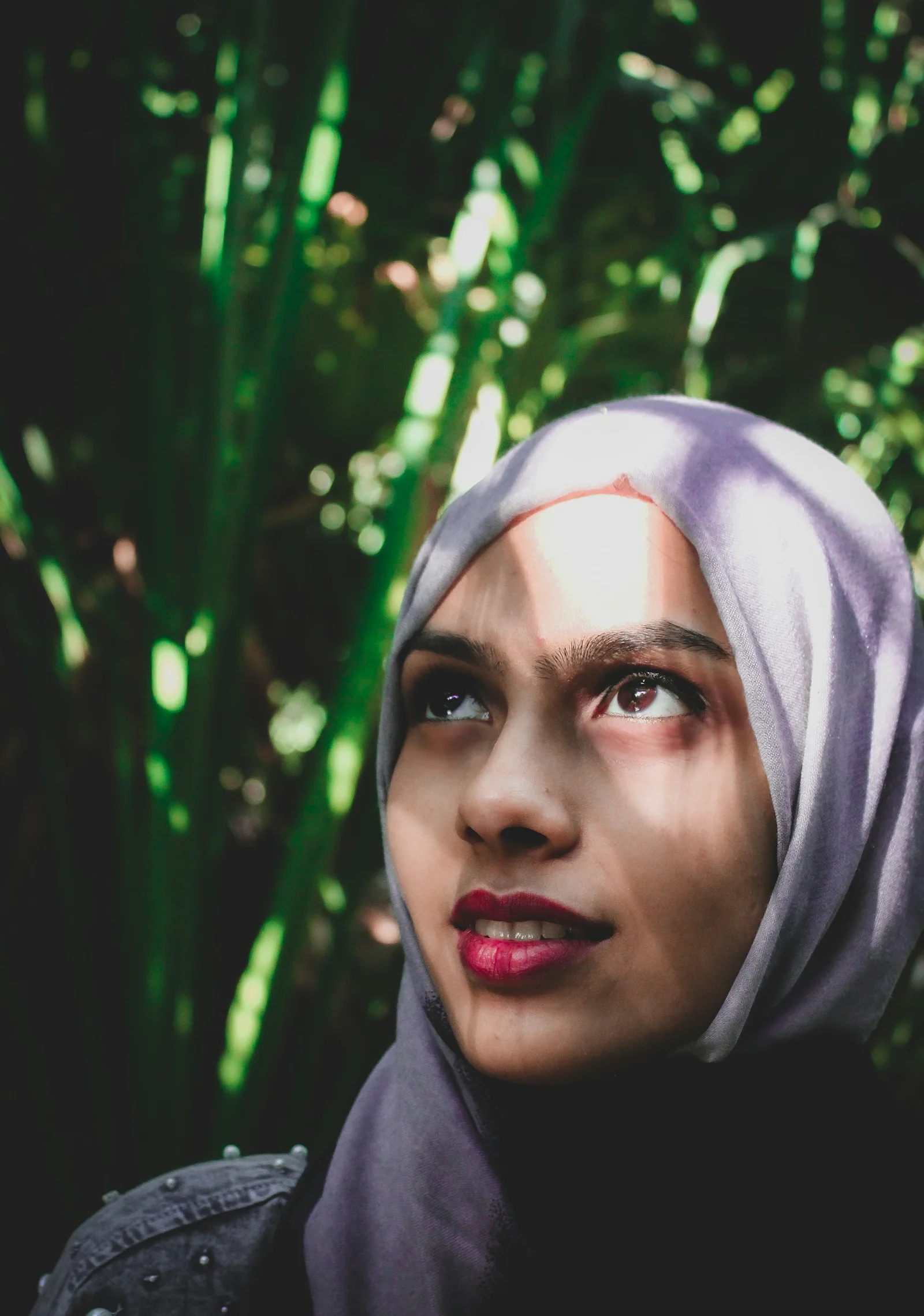 woman in white hijab near green leaves