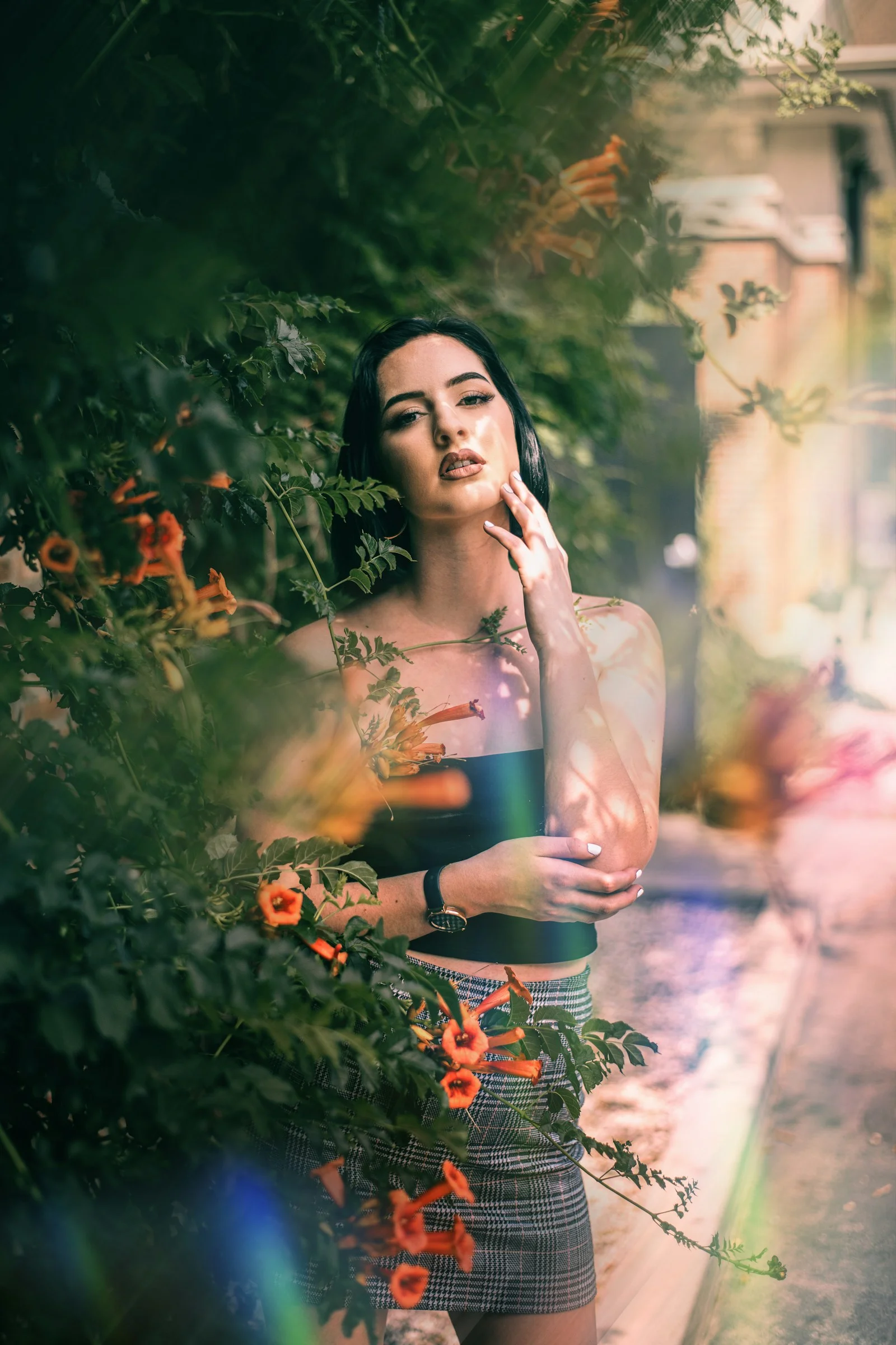a woman standing in front of some flowers