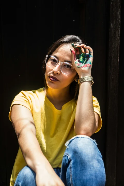 woman in yellow t-shirt and blue denim jeans