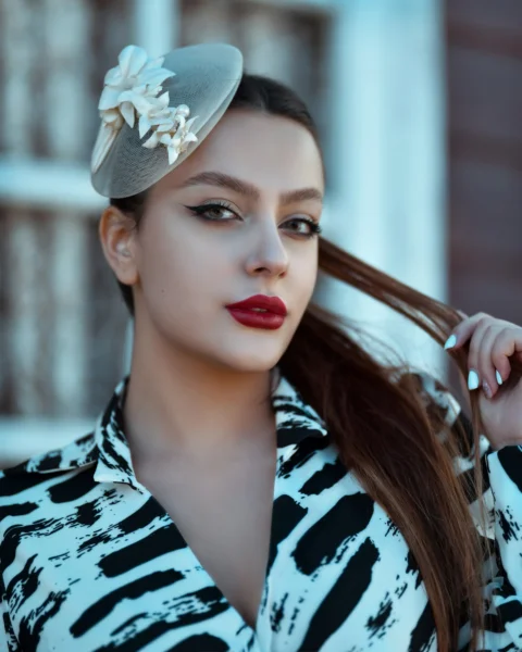 woman in black and white floral shirt wearing gray floral headband