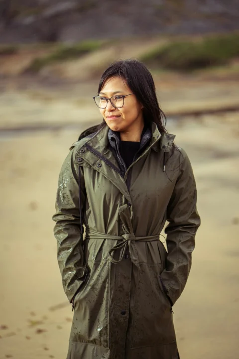 woman in black coat wearing black framed eyeglasses