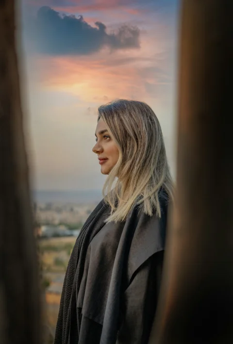 Young woman looking at sunset sky
