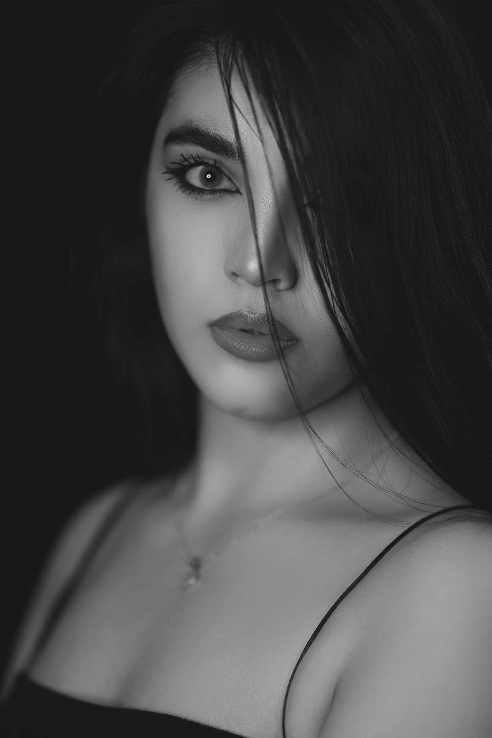 a black and white photo of a woman with long hair